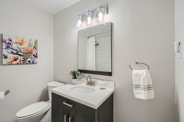 bathroom featuring vanity, toilet, and a shower with curtain