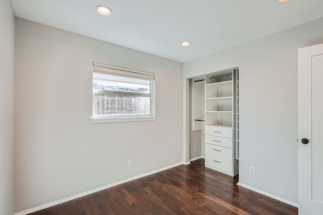 unfurnished bedroom with a closet and dark hardwood / wood-style flooring