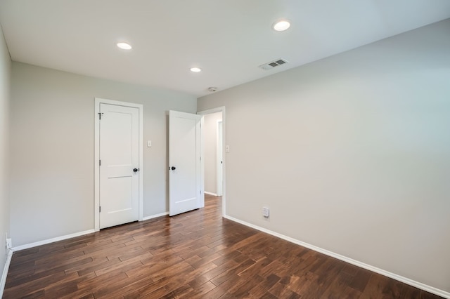 unfurnished bedroom with dark hardwood / wood-style floors