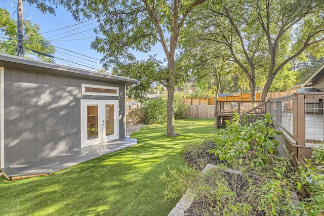 view of yard with a wooden deck and french doors