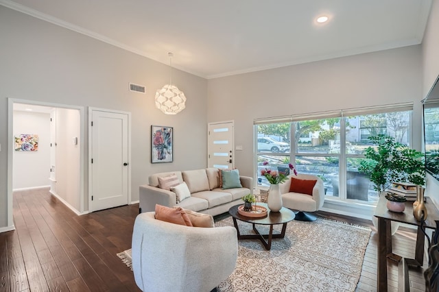 living room with crown molding, a high ceiling, and dark hardwood / wood-style flooring