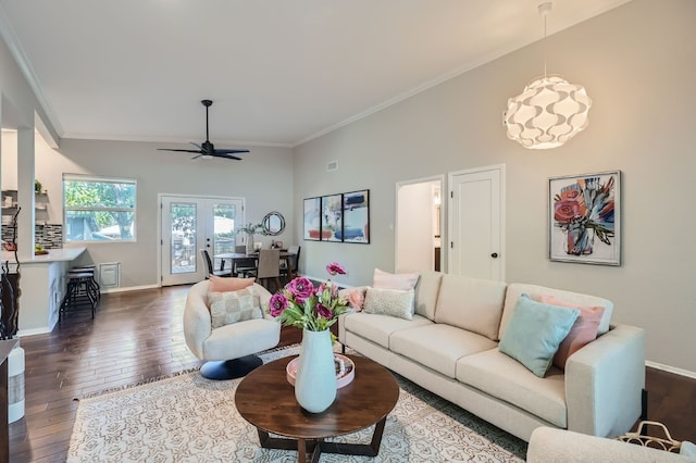 living room featuring vaulted ceiling, dark wood-type flooring, ceiling fan, french doors, and ornamental molding