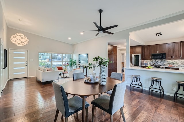 dining area with ceiling fan, ornamental molding, and dark hardwood / wood-style flooring