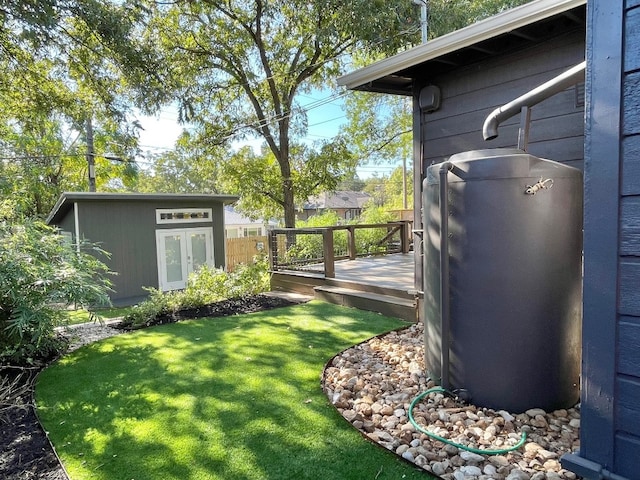 view of yard featuring an outdoor structure and a deck