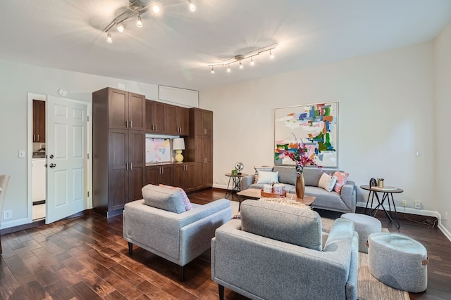 living room featuring dark hardwood / wood-style floors and track lighting