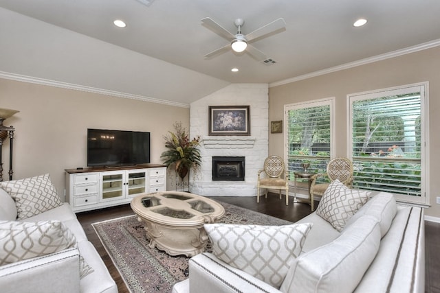 living room featuring ceiling fan, a fireplace, and dark hardwood / wood-style flooring