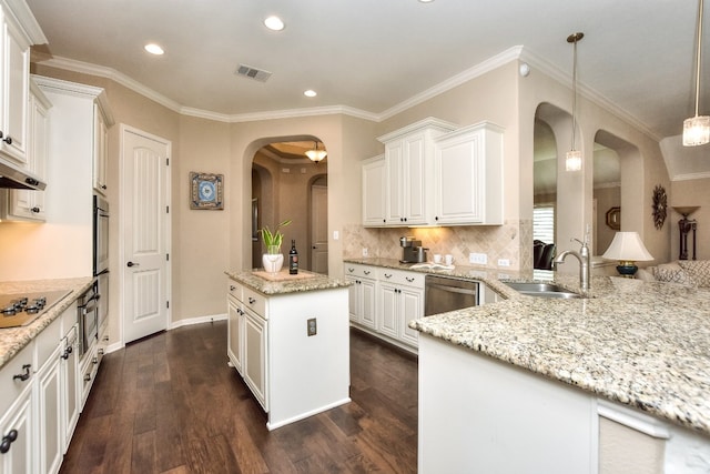 kitchen featuring a center island, dark hardwood / wood-style floors, sink, white cabinetry, and decorative light fixtures