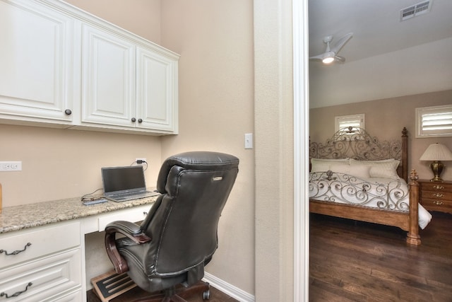 home office featuring built in desk and dark wood-type flooring