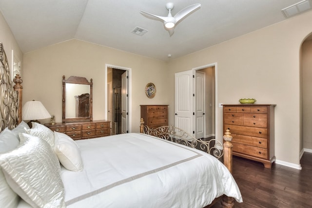 bedroom with ceiling fan, vaulted ceiling, and dark hardwood / wood-style flooring