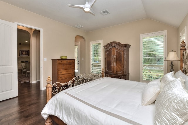 bedroom featuring vaulted ceiling, dark wood-type flooring, and ceiling fan