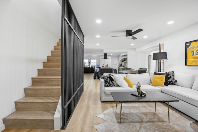 living room featuring light wood-type flooring and ceiling fan