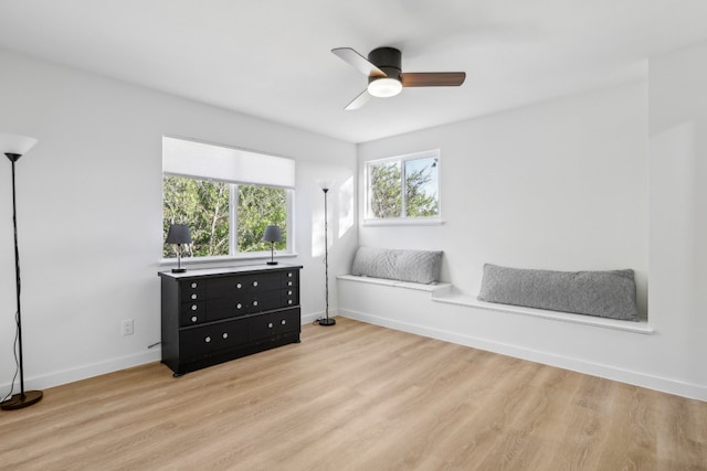 bedroom with light hardwood / wood-style floors, multiple windows, and ceiling fan