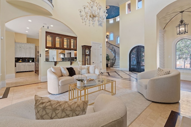 living room with a chandelier and a high ceiling