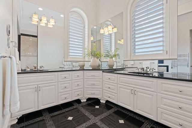 bathroom featuring crown molding, tile patterned floors, and vanity