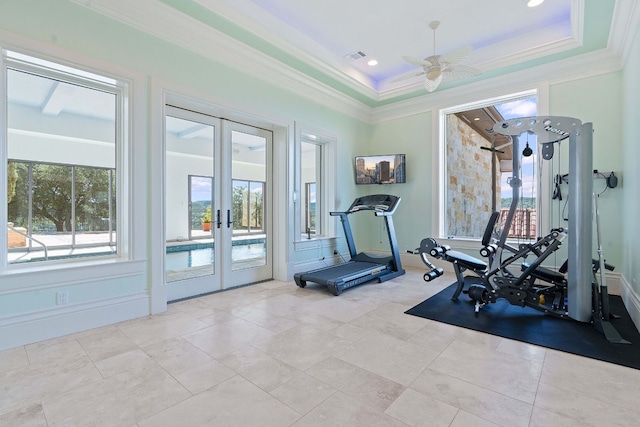 exercise room featuring ornamental molding, french doors, a raised ceiling, and light tile patterned flooring