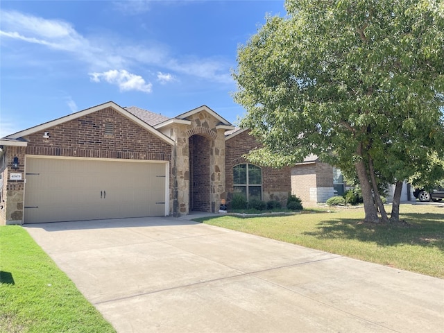 view of front of house with a front lawn and a garage