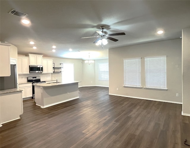 kitchen featuring white cabinetry, stainless steel appliances, a kitchen island with sink, and dark wood-type flooring