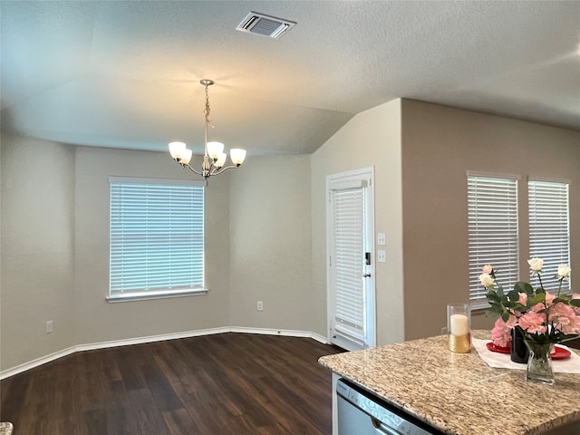 kitchen with dark wood-type flooring, an inviting chandelier, plenty of natural light, lofted ceiling, and decorative light fixtures