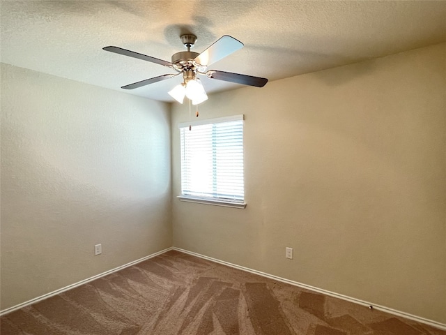 carpeted spare room featuring a textured ceiling and ceiling fan