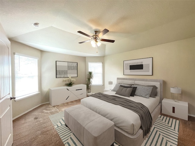 carpeted bedroom featuring ceiling fan, lofted ceiling, and a textured ceiling