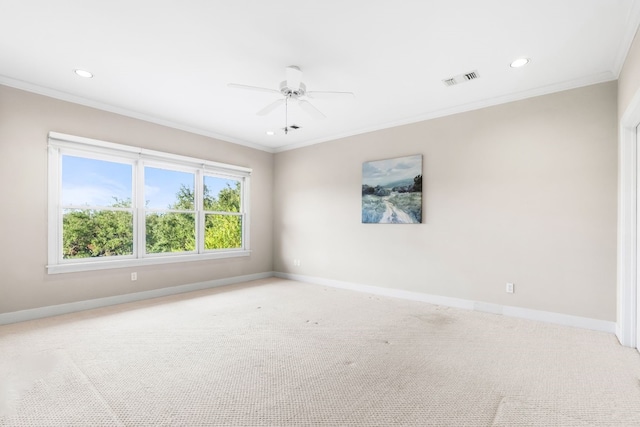 carpeted empty room featuring ceiling fan and crown molding