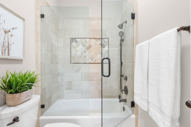 bathroom with shower / bath combination with glass door and toilet