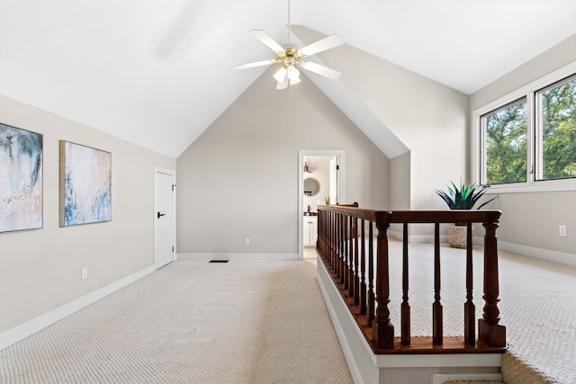 corridor with light carpet and vaulted ceiling