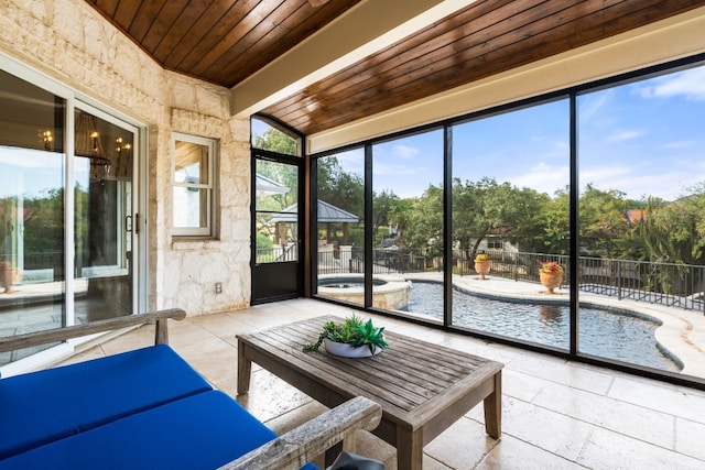 unfurnished sunroom featuring wood ceiling and beam ceiling