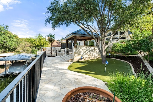 3605 Douglas Dr, Horseshoe Bay, TX 78657 - surrounding community with an area to practice putting, a gazebo, boat lift, and a boat dock