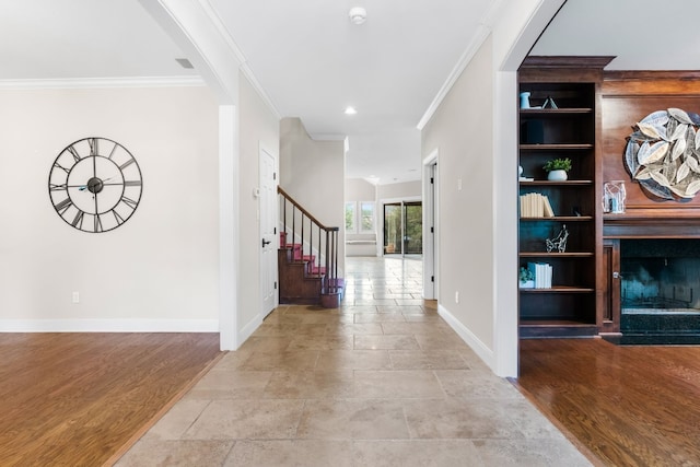 3605 Douglas Dr, Horseshoe Bay, TX 78657 - corridor with ornamental molding, baseboards, stairway, stone finish flooring, and arched walkways