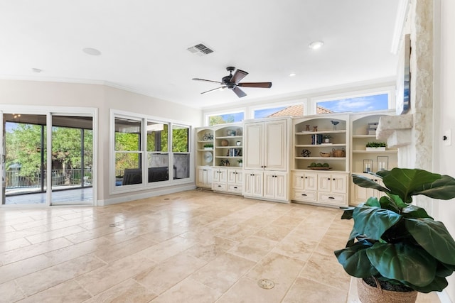 unfurnished living room with crown molding, ceiling fan, and a wealth of natural light