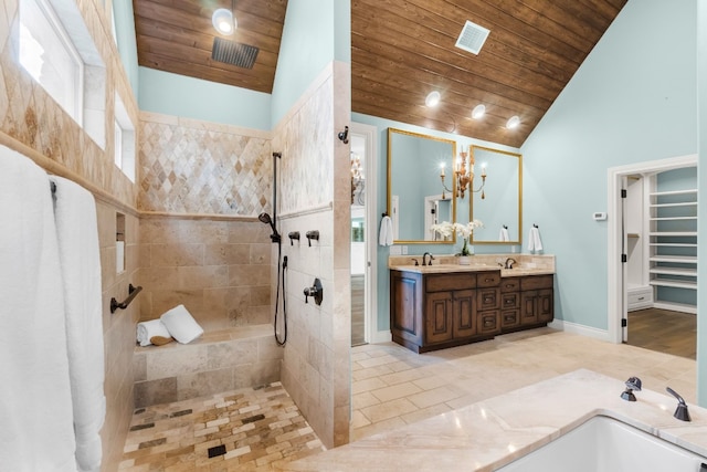 bathroom with high vaulted ceiling, vanity, wooden ceiling, a tile shower, and tile patterned floors