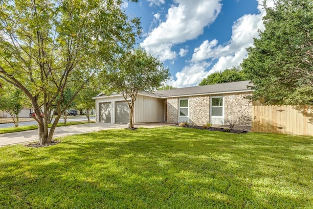 ranch-style home featuring a garage and a front lawn