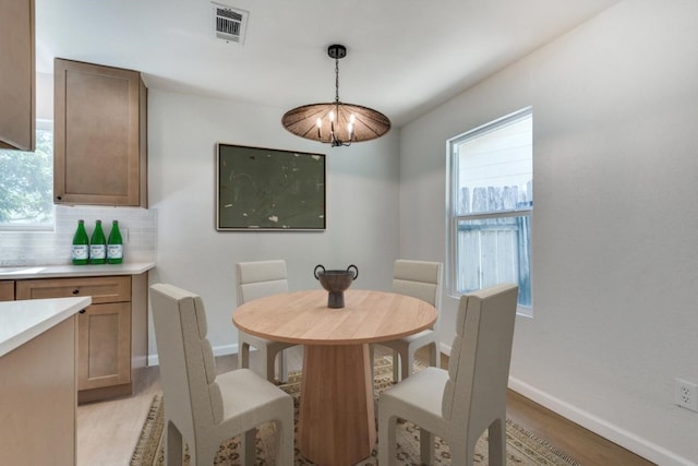 dining area with light hardwood / wood-style floors