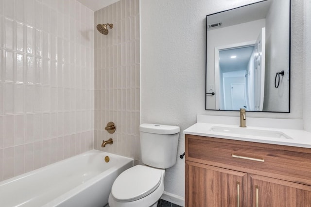 full bathroom with vanity, tiled shower / bath combo, and toilet