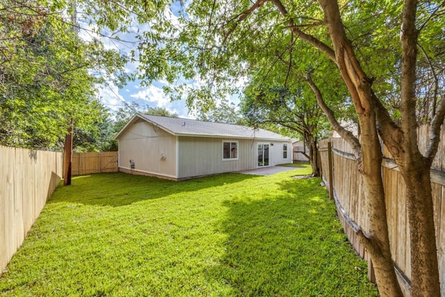 back of house featuring a yard and a patio