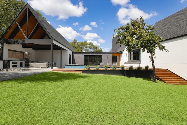 view of yard with a patio, ceiling fan, and exterior kitchen