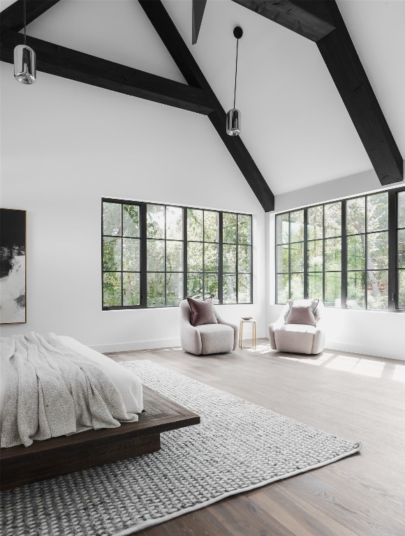 bedroom featuring hardwood / wood-style flooring, beamed ceiling, and high vaulted ceiling