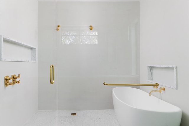 bathroom with tile patterned flooring and a shower with door