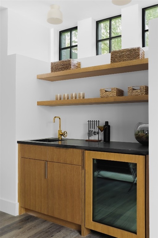 bar with wine cooler, dark hardwood / wood-style floors, sink, and a healthy amount of sunlight