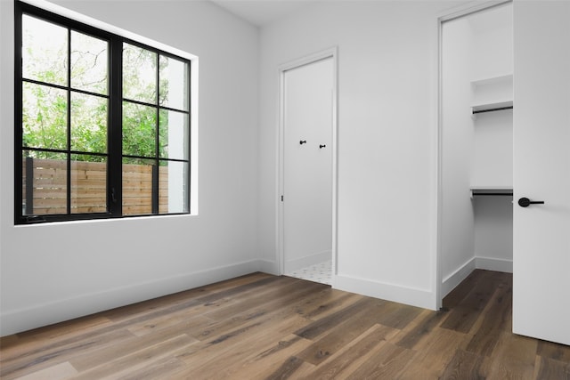 unfurnished bedroom featuring dark hardwood / wood-style floors