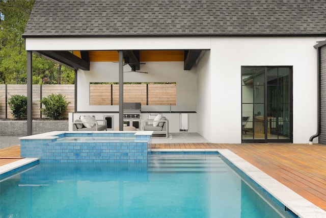 view of pool with ceiling fan and a wooden deck