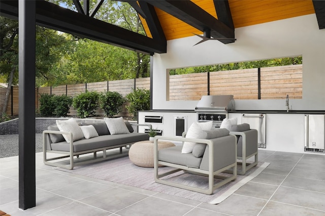 view of patio with grilling area, area for grilling, sink, and ceiling fan