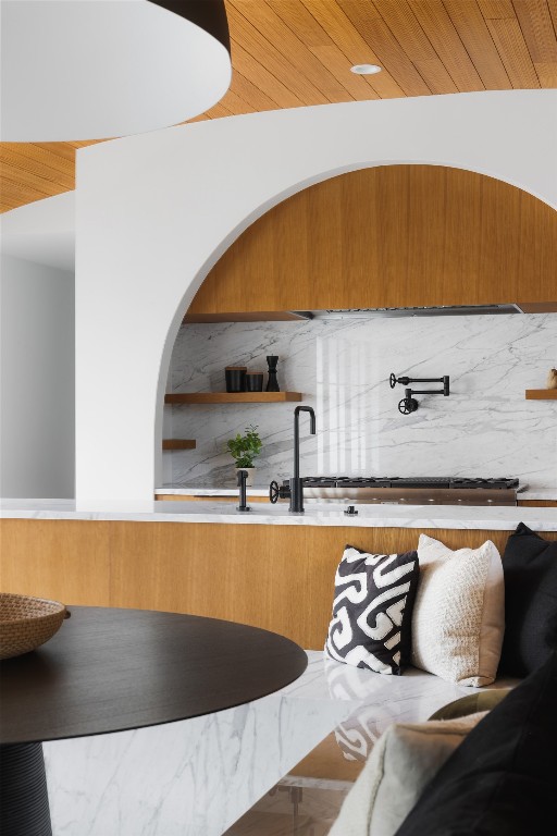 bar featuring wood ceiling and backsplash