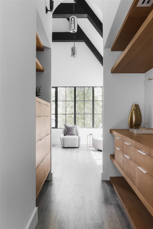 bedroom with high vaulted ceiling, beamed ceiling, and dark hardwood / wood-style flooring