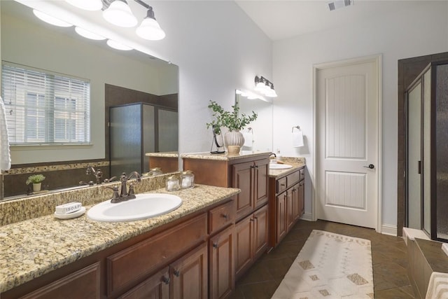 bathroom with tile patterned floors, vanity, and walk in shower