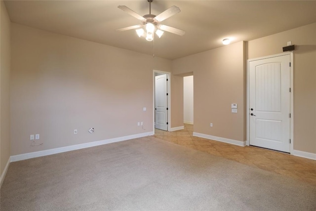 unfurnished room featuring light carpet and ceiling fan