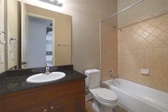 full bathroom featuring vanity, toilet, and tiled shower / bath combo