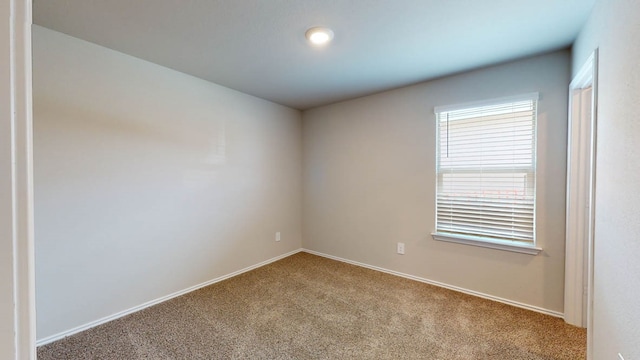 unfurnished room with light colored carpet