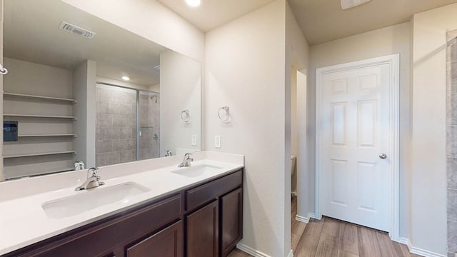 bathroom with vanity, hardwood / wood-style floors, and an enclosed shower